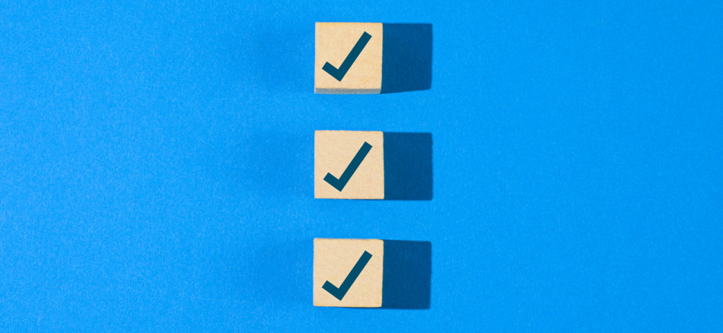Three checkmarks in a vertical row on a blue background