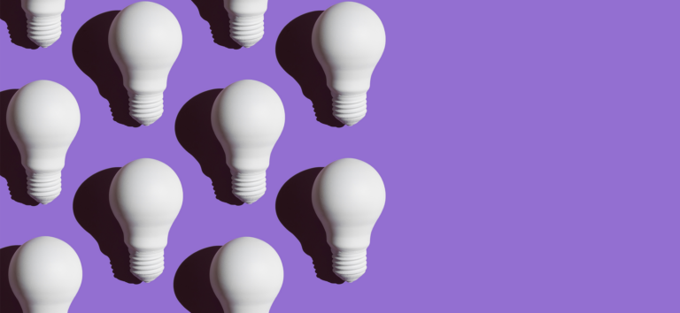 White lightbulbs on a purple background. This represents ideas on personalization best practices for marketers.