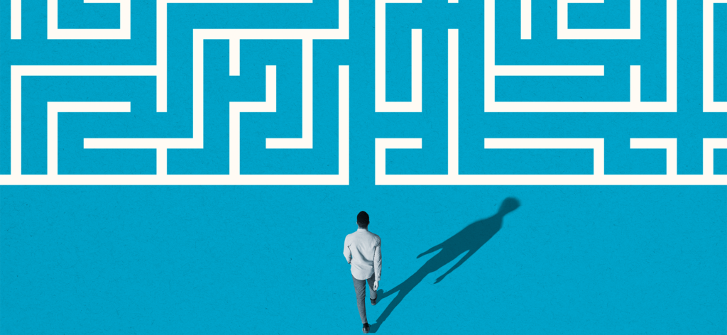 Man in business attire walking towards a maze, symbolizing potential CDP challenges business leaders could face.